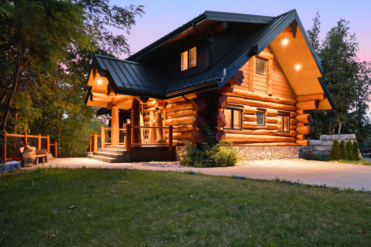 Bear Lodge exterior at twilight with warm lighting and a spacious front lawn