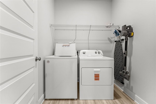 Laundry room is off the living space and has an iron/ironing board and vaccum