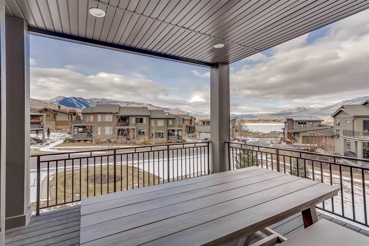 Covered deck with outdoor seating and sweeping valley views