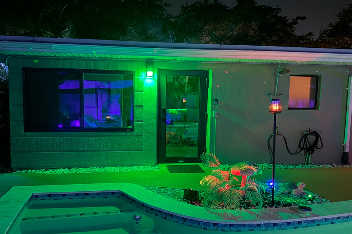 Night exterior view of The Green Room at Garden of Manors, featuring ambient lighting and poolside surroundings.