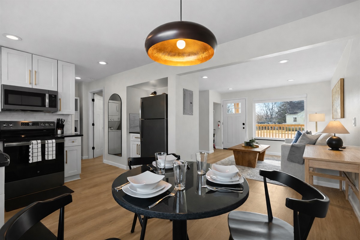 Open-concept dining and kitchen area with modern finishes, warm lighting, and seamless flow into the living space—perfect for meals, entertaining, and relaxing together.