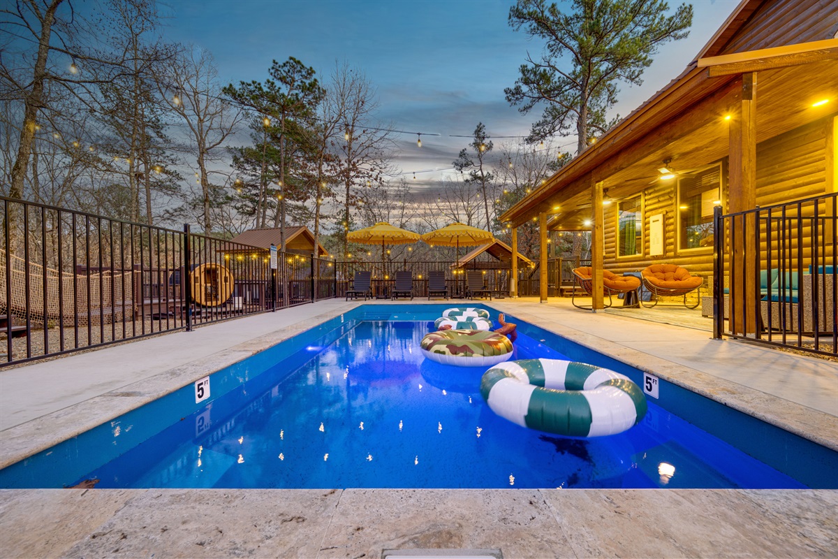 Pool Paradise: Dive into relaxation with floating fun and twinkling lights! Enjoy the adventure!