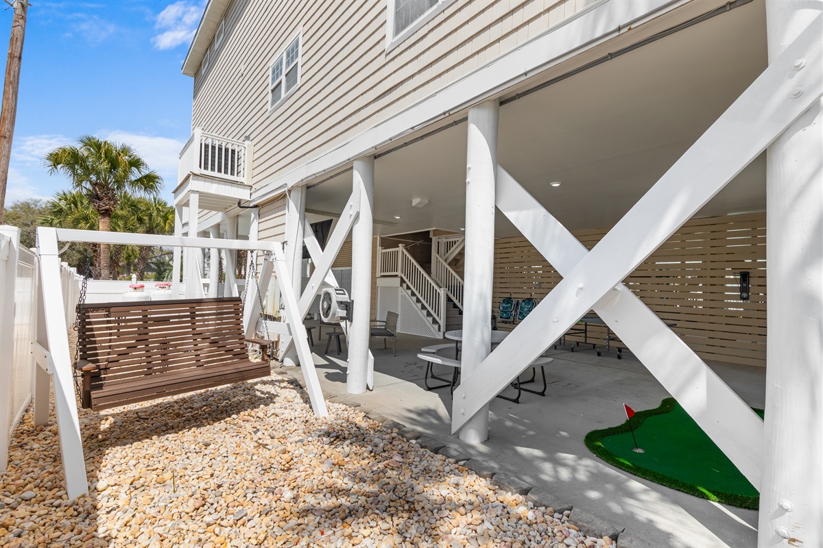 Watch the ocean from the relaxing swing outside the outdoor entertainment area.
