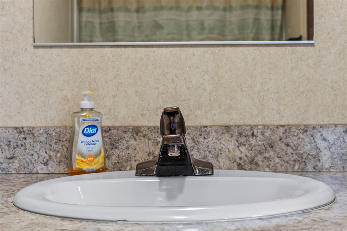 Bright vanity area with a wide mirror and well-lit sink—perfect for getting ready with ease.