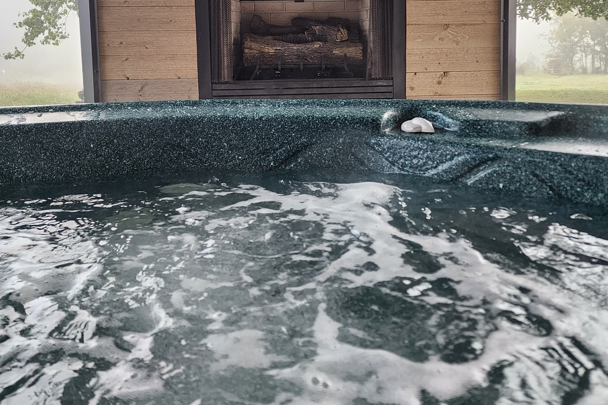 Hot tub located by the out door fireplace