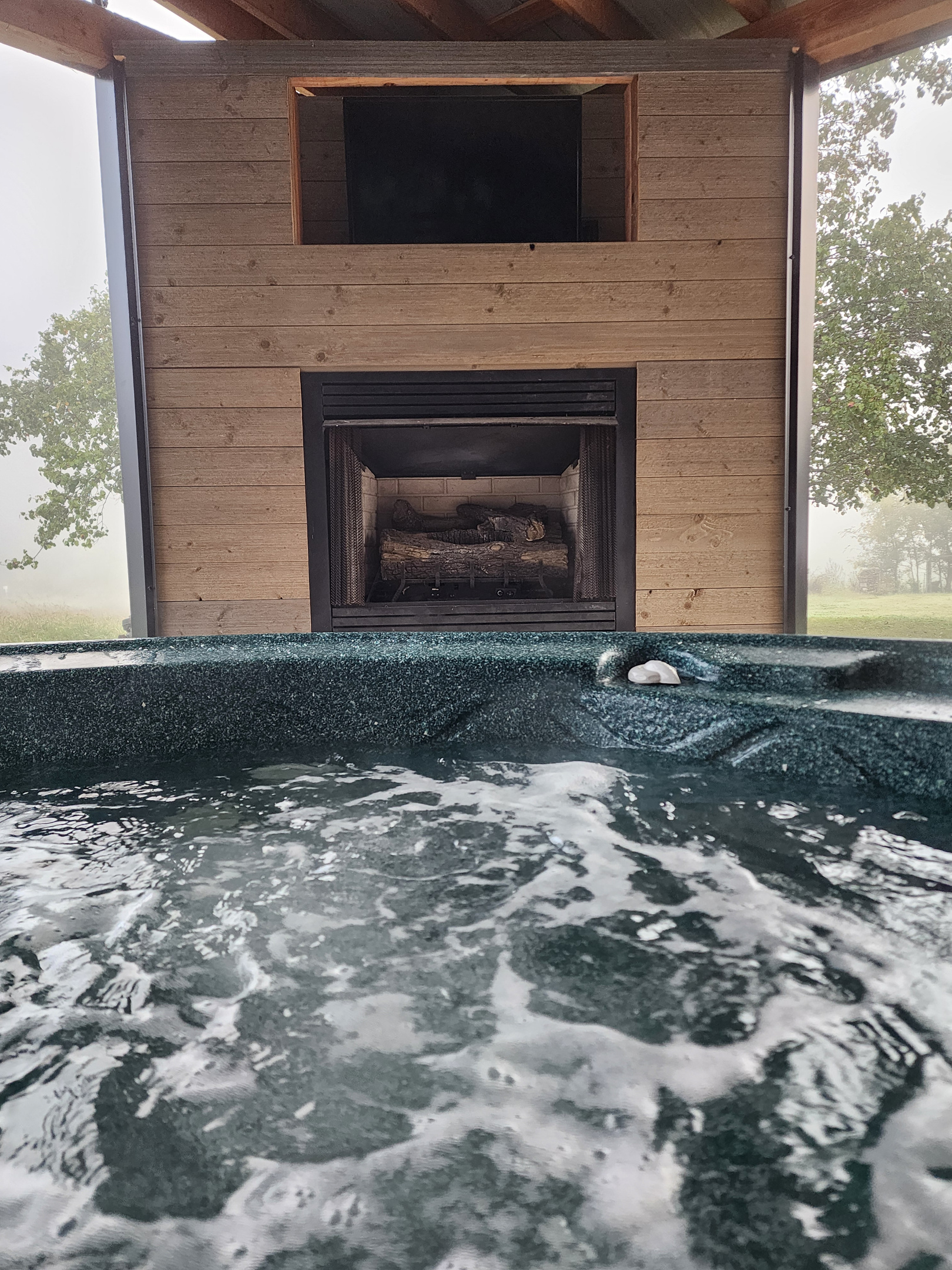 Hot tub located by the out door fireplace