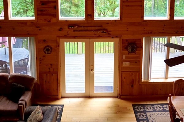 Towering windows frame stunning forest views, inviting nature inside for your escape!