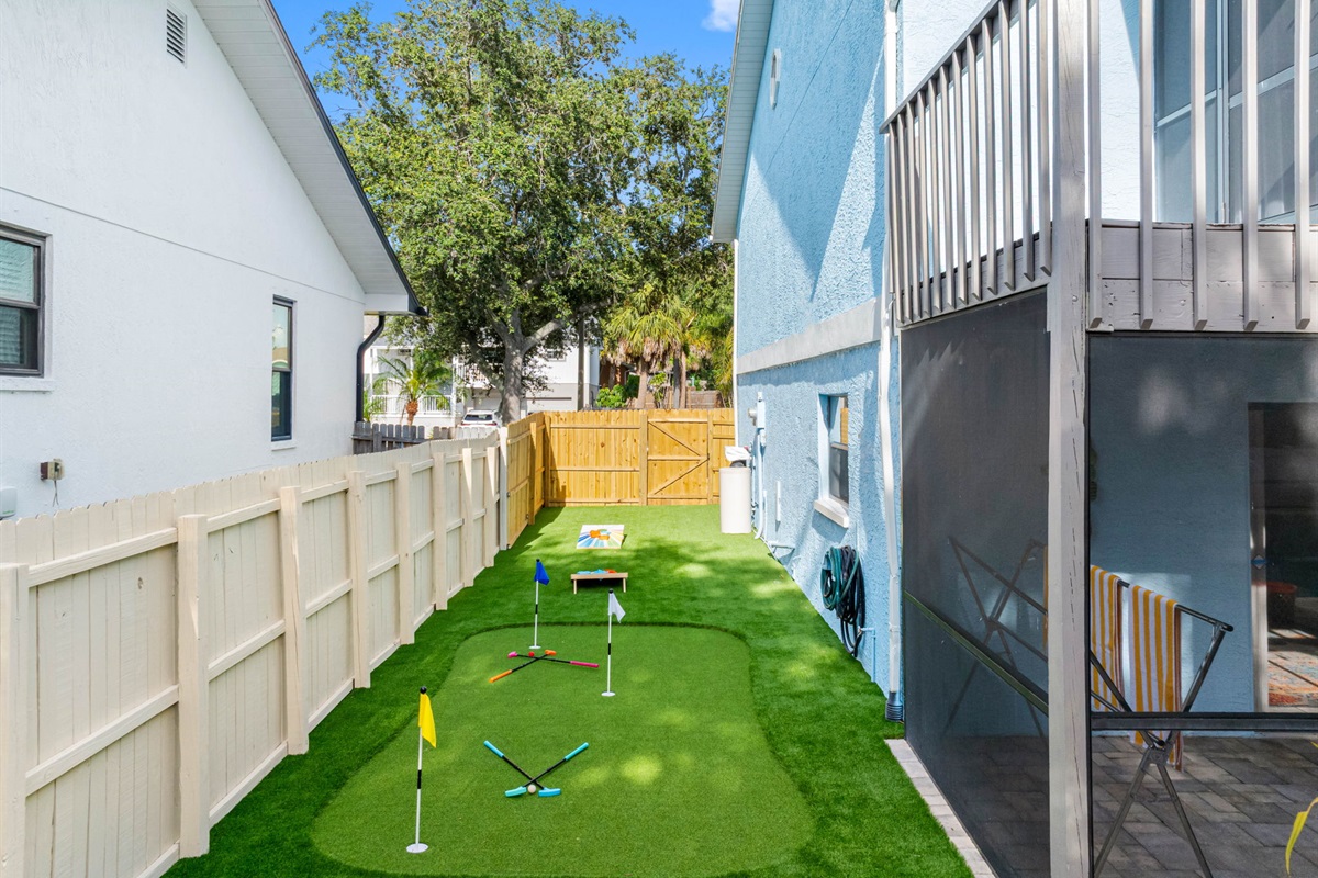 With a colorful cornhole set and putting green just steps from the patio, this fenced-in yard offers endless entertainment without leaving home.