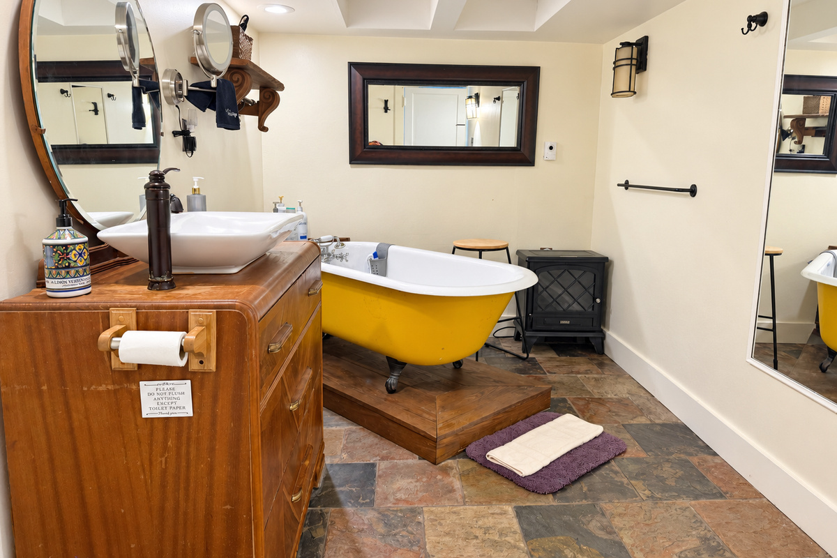Bath w/ vintage clawfoot tub on lower level next to game room