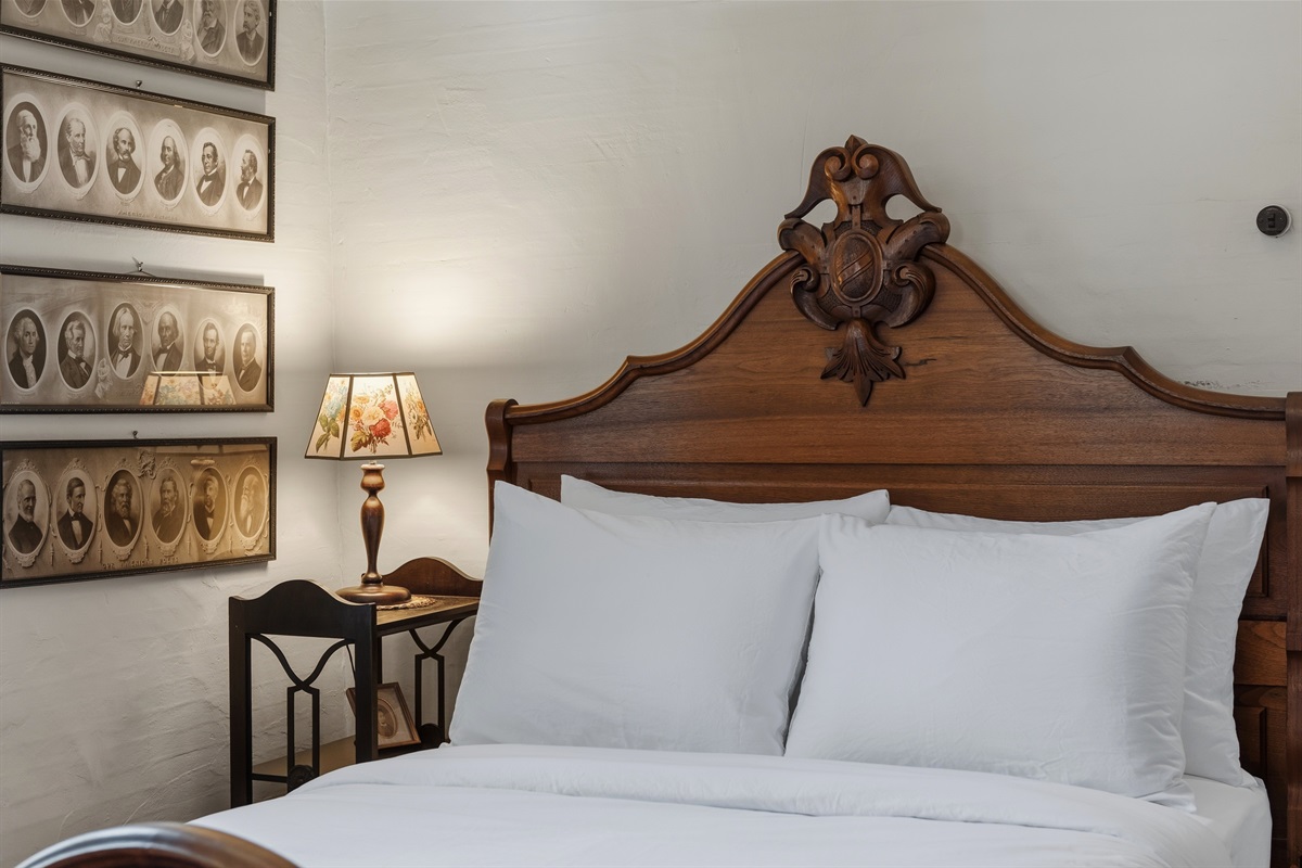 Queen bedroom on main floor w/ classic wood bed frame