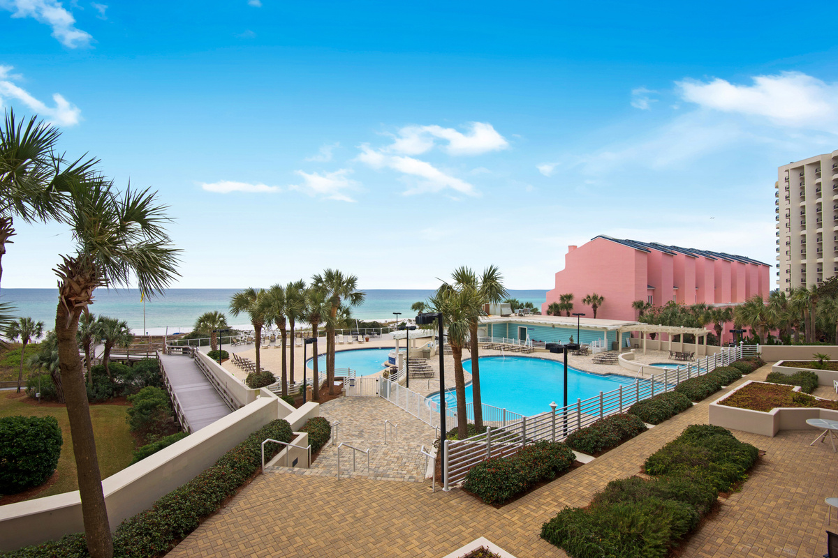 Wide view across the pools and beach to the Gulf.