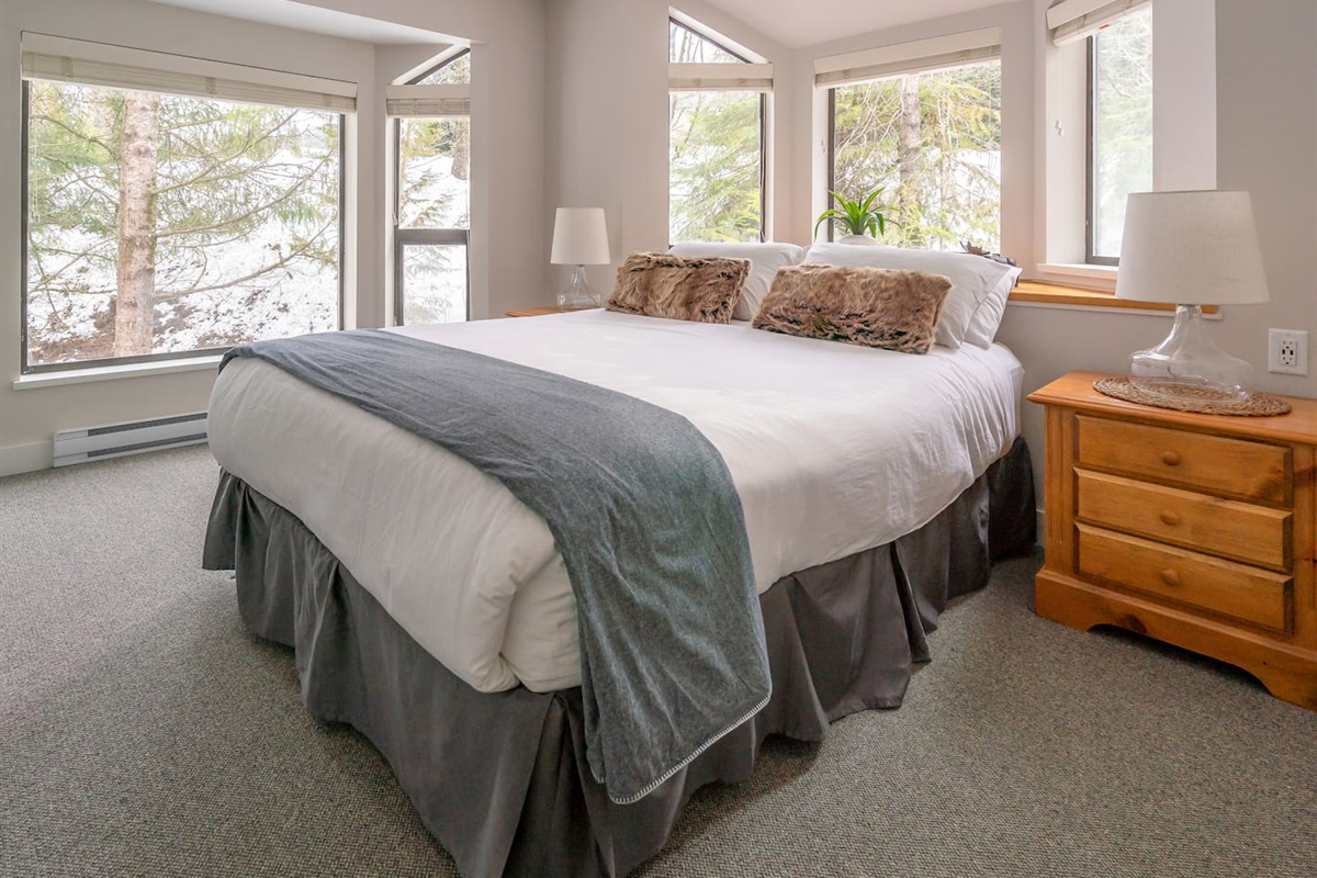 Bedroom#1's proximity to the surrounding mountains is accentuated by large windows that frame 2 walls.  Luxurious Queen bed, integrated closet system w/ motion-activated light, HD TV & elevated USB Type C & A wall outlets complete this room. 