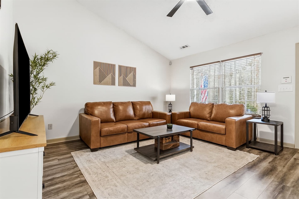 Living Room with 65" Smart TV, dedicated workspace, cards, board games and cozy seating!