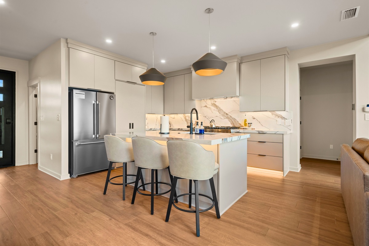 Warm wood tones and crisp, modern finishes give this space a cozy-yet-updated feel, making it both stylish and comfortable for everyday living.