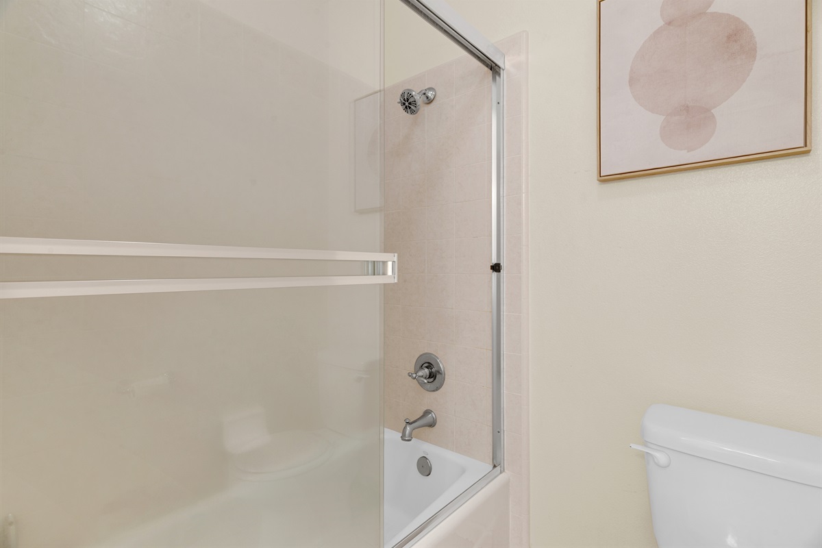 Full bathroom includes a tub and shower as well as two double sinks.