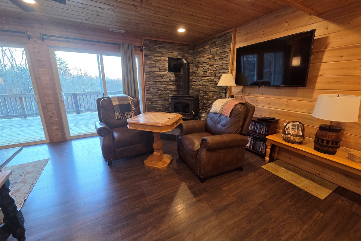 Unwind in the comfy chairs by the fireplace, enjoy a game with family or friends, and admire the scenic views through the front sliding doors.