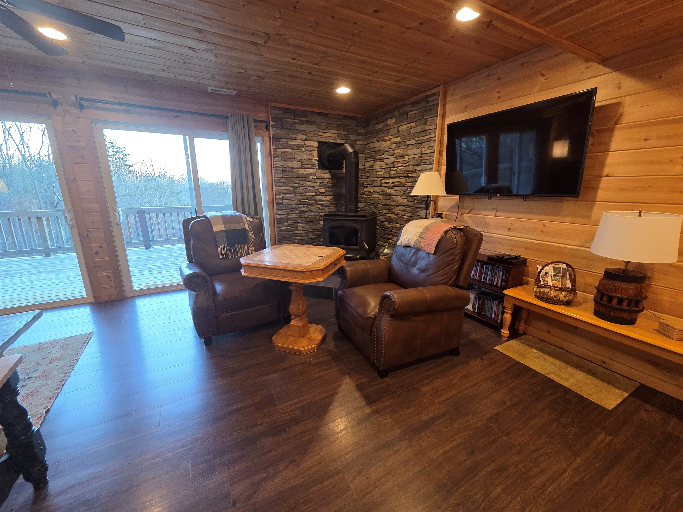 Unwind in the comfy chairs by the fireplace, enjoy a game with family or friends, and admire the scenic views through the front sliding doors.