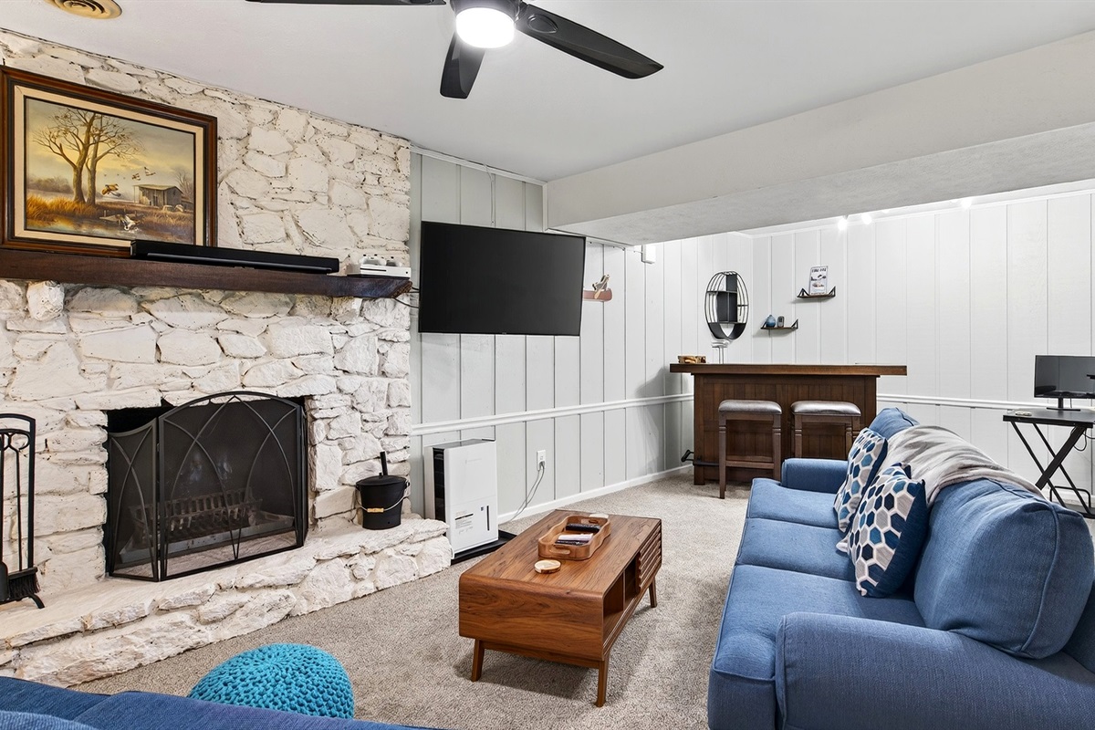 Lower level living area includes a fireplace and a TV