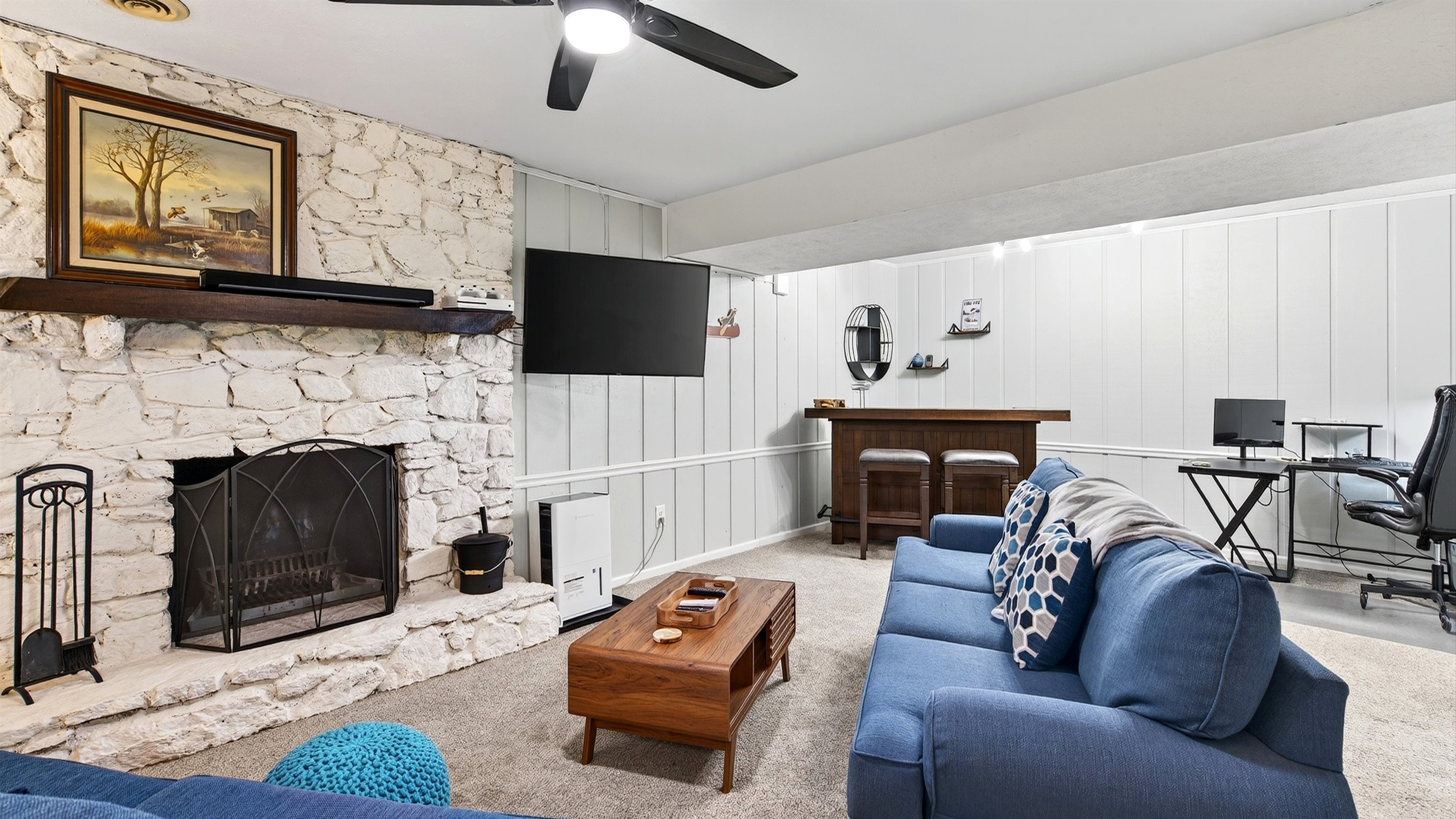 Lower level living area includes a fireplace and a TV