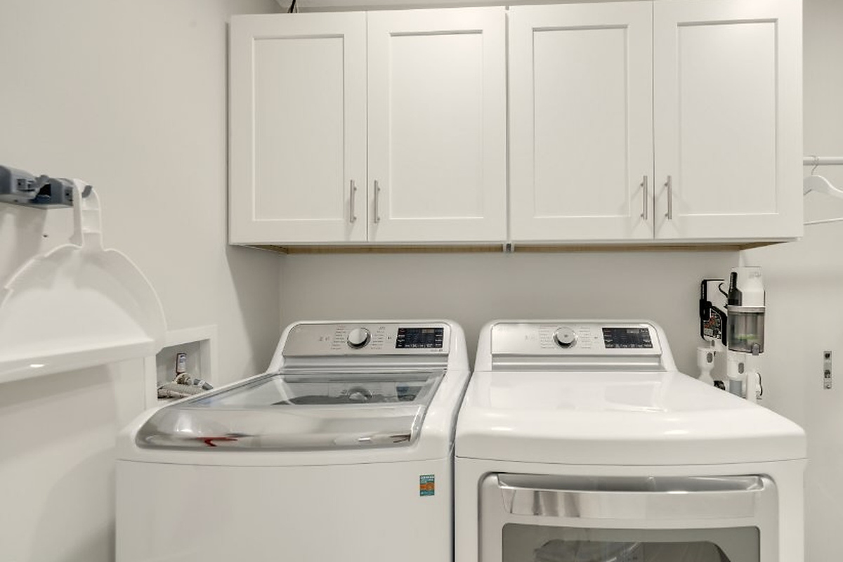 In-home laundry with cabinets and hanging space makes it easier to pack light and keep beach towels and clothes fresh.