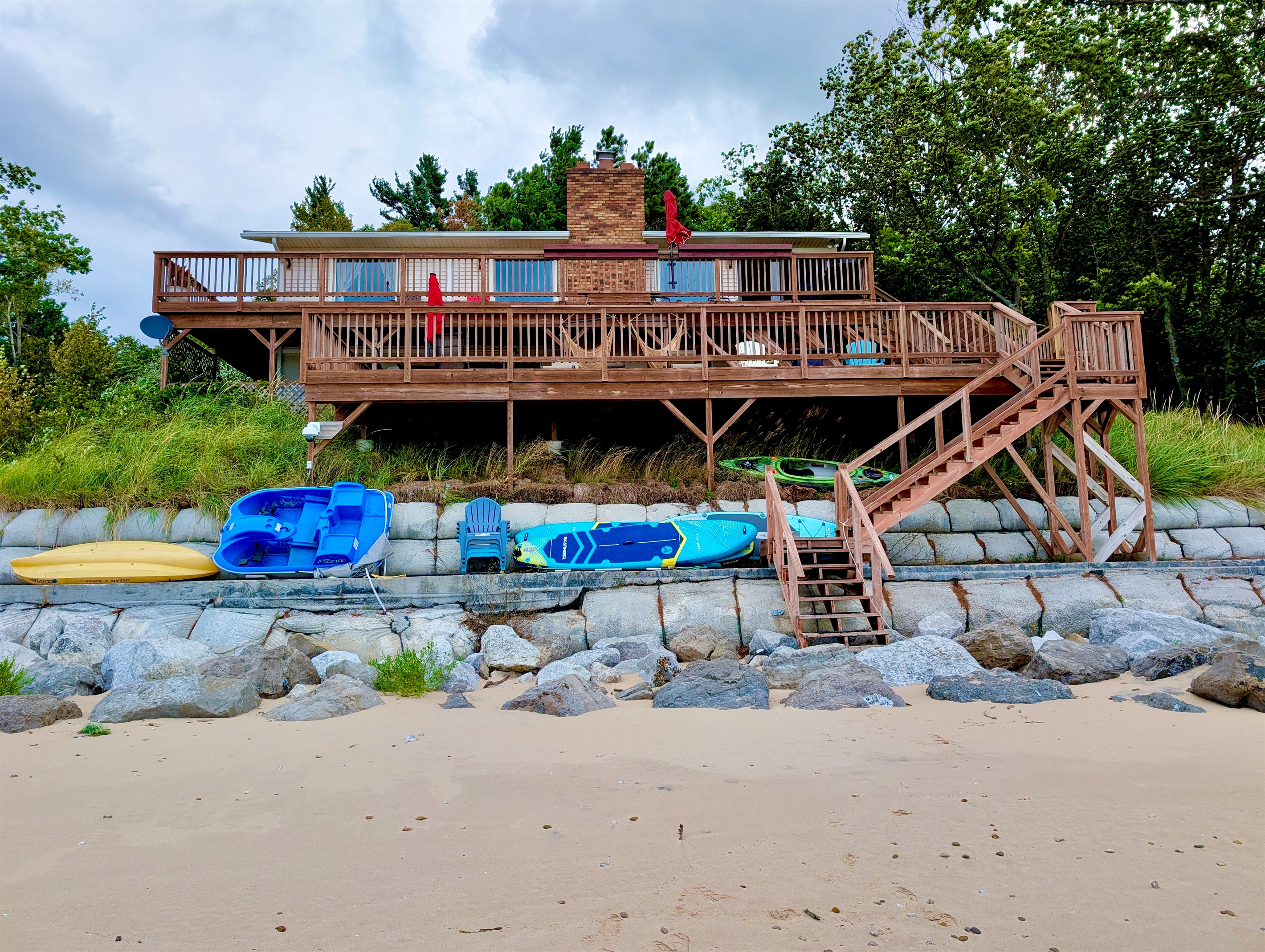 Front of the cottage and large deck. View from the Lake.