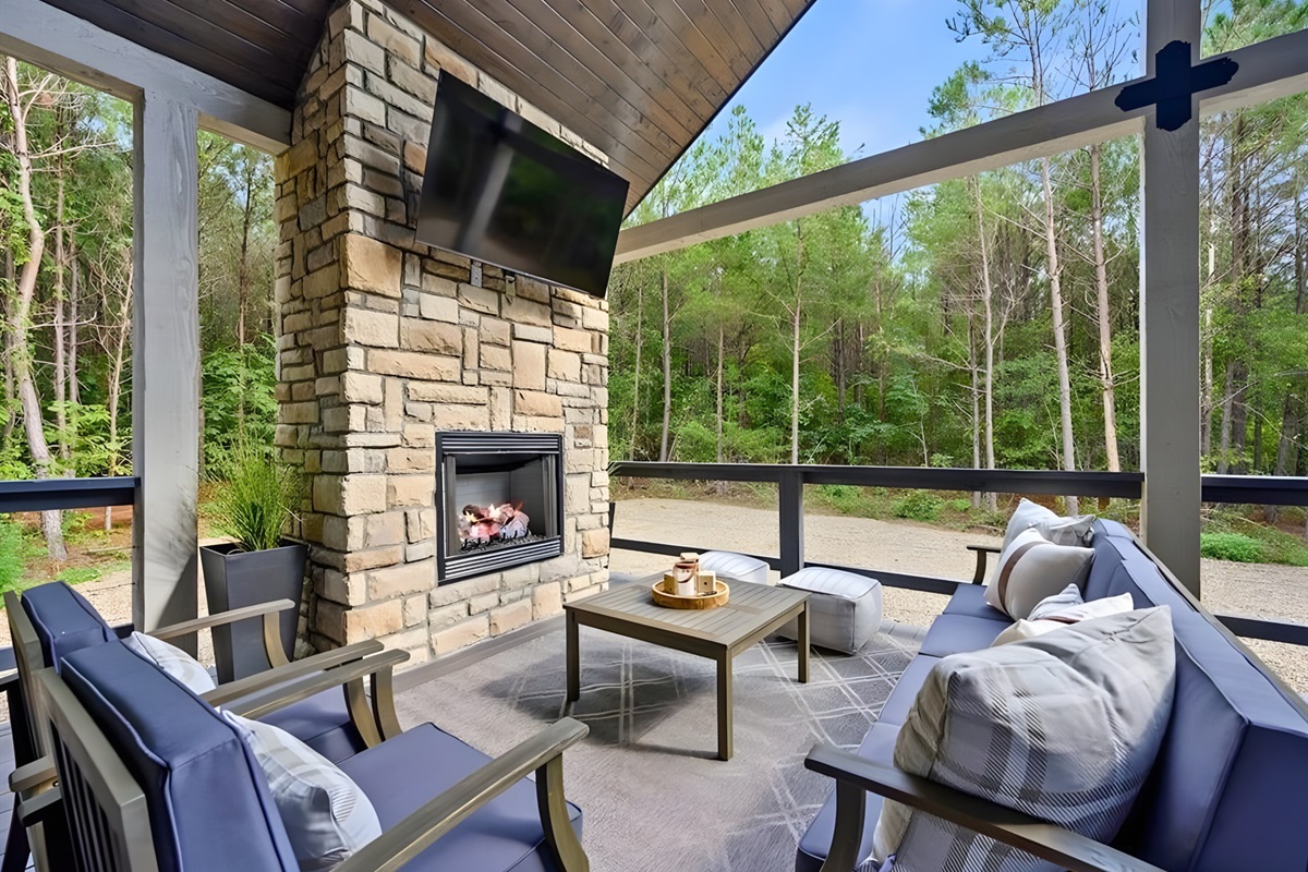 The covered patio creates an outdoor living room complete with a fireplace for year-round comfort.