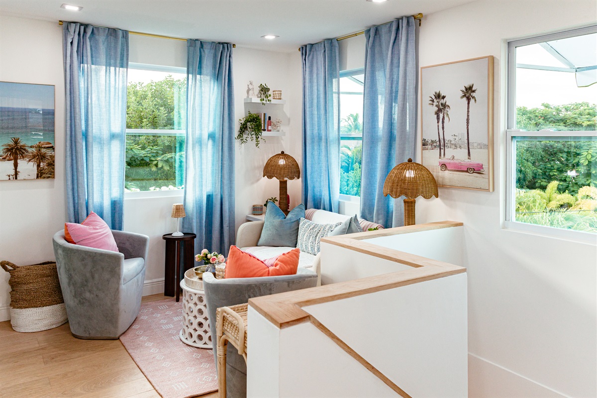 The second floor of the cottage has a cozy seating area, with the elevated setting letting in much natural light as you take in a birds-eye view of the surroundings.