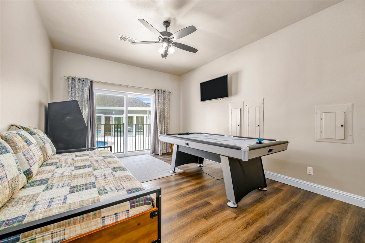 Main level daybed with Trundle. An arcade game and air hockey table will be so much fun for kiddos! There are a total of 4 stairs to navigate down to reach this bedroom.
