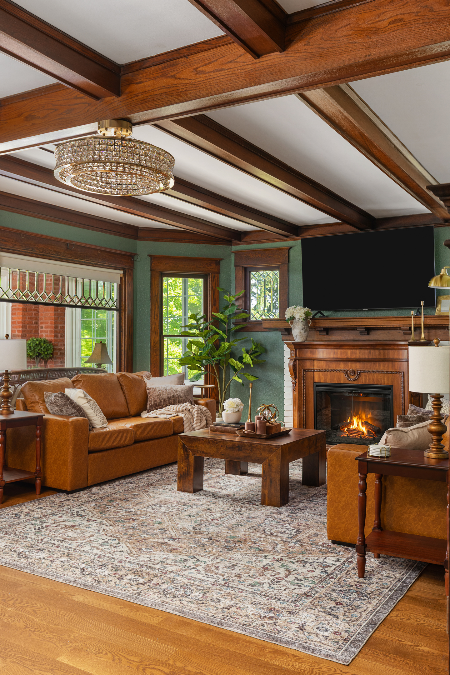 Gather beneath rich wood beams and cozy heritage inspired details in this warm, inviting living room designed for connection and relaxation. Unwind after a great day in a space that feels equal parts timeless and luxurious.