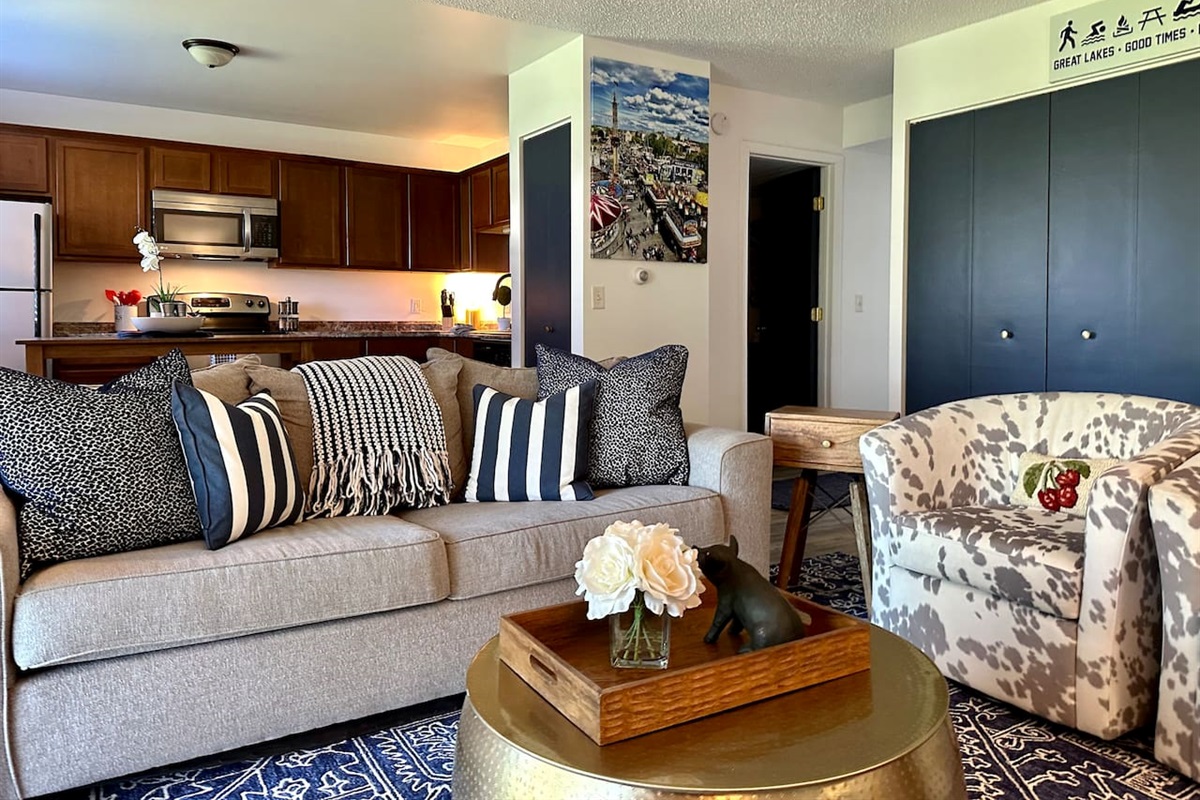 Chic and cheerful living space with bold accents, plush seating, and playful decor. Features include a full kitchen, fast Wi-Fi, smart TV, and cozy lounge chairs. Perfect for relaxing after exploring stylish comfort meets convenience in every detail.