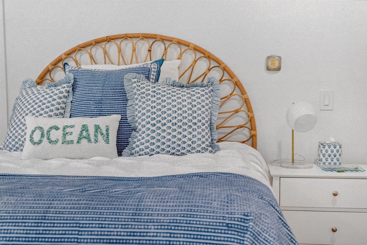 The second bedroom offers a warm and relaxing space with a plush queen bed.