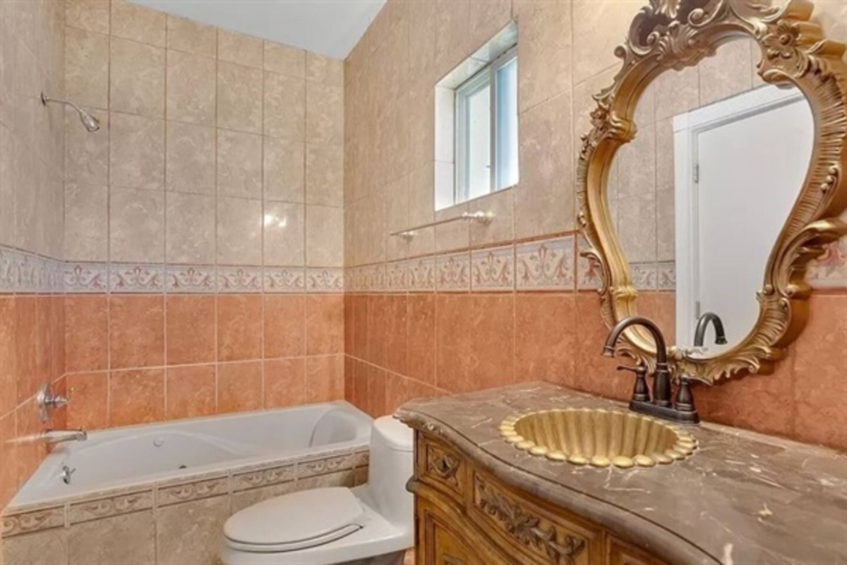 Soft lighting and earthy tilework create a warm, welcoming vibe for your morning routine or evening wind-down.