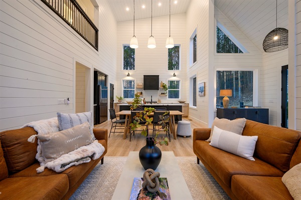 From the cozy leather sofas to the dining table and into the stunning kitchen beyond, the open layout invites everyone to gather and stay connected.