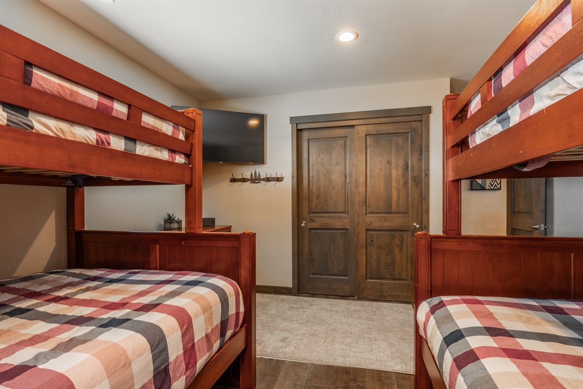 Located on the mid-level, the bunkroom offers easy access to a full bath and separation from the primary suites above.