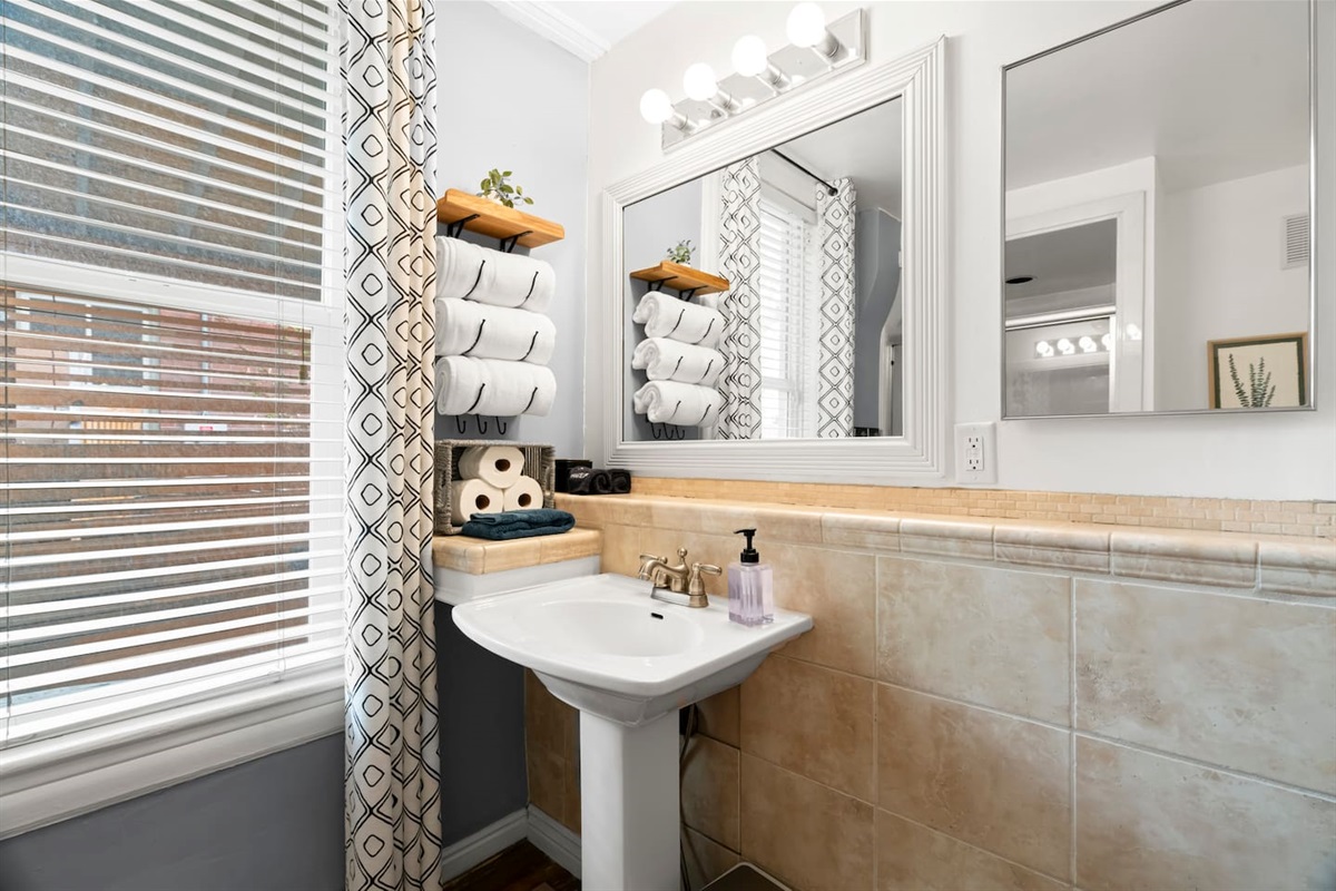Functional, fresh, and full of character — this hall bath keeps things classic with a wink to the past.