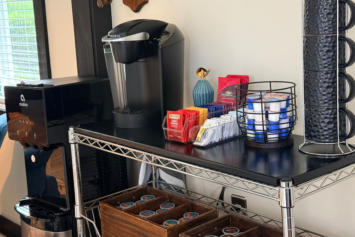 Coffee bar with Keurig and drip coffee options, tea, cocoa, cappuccino, and supplies.