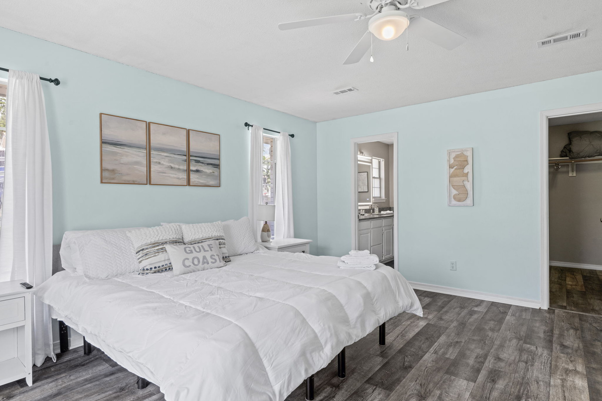 Coastal-inspired comfort with direct access to a private en-suite bath and walk-in closet.