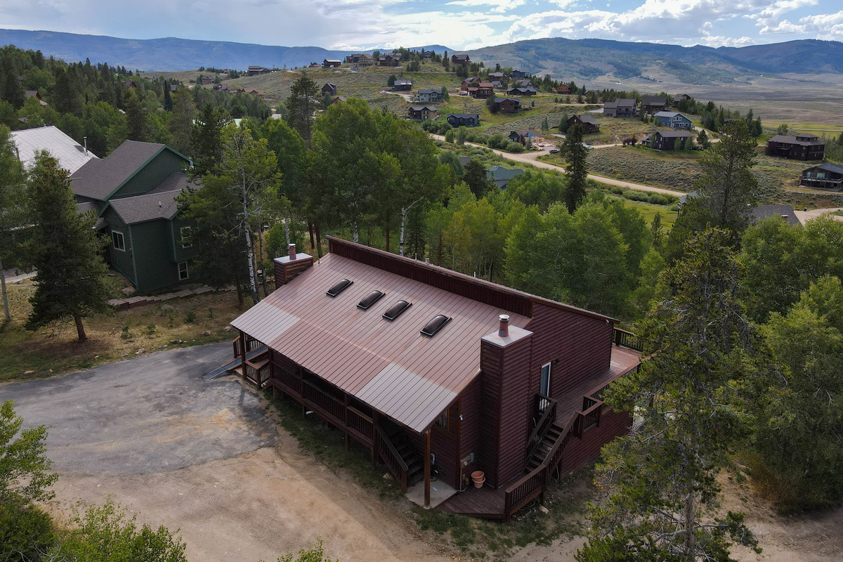 Summer aerial view of the home and mountains