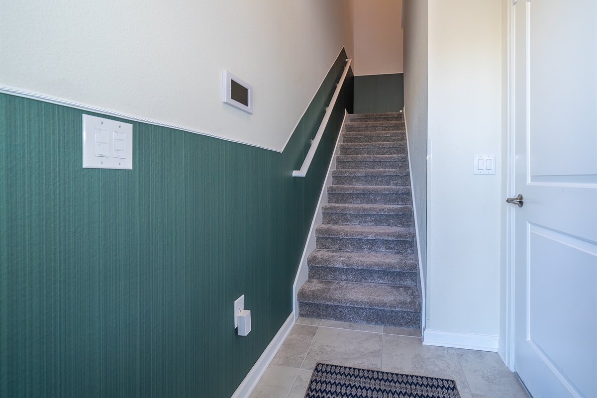 Stairs from front door and garage