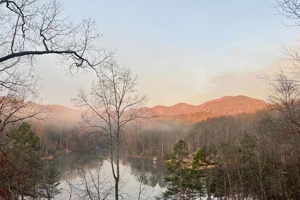 Sunrise view of Rumbling Bald mountain and lake from balcony