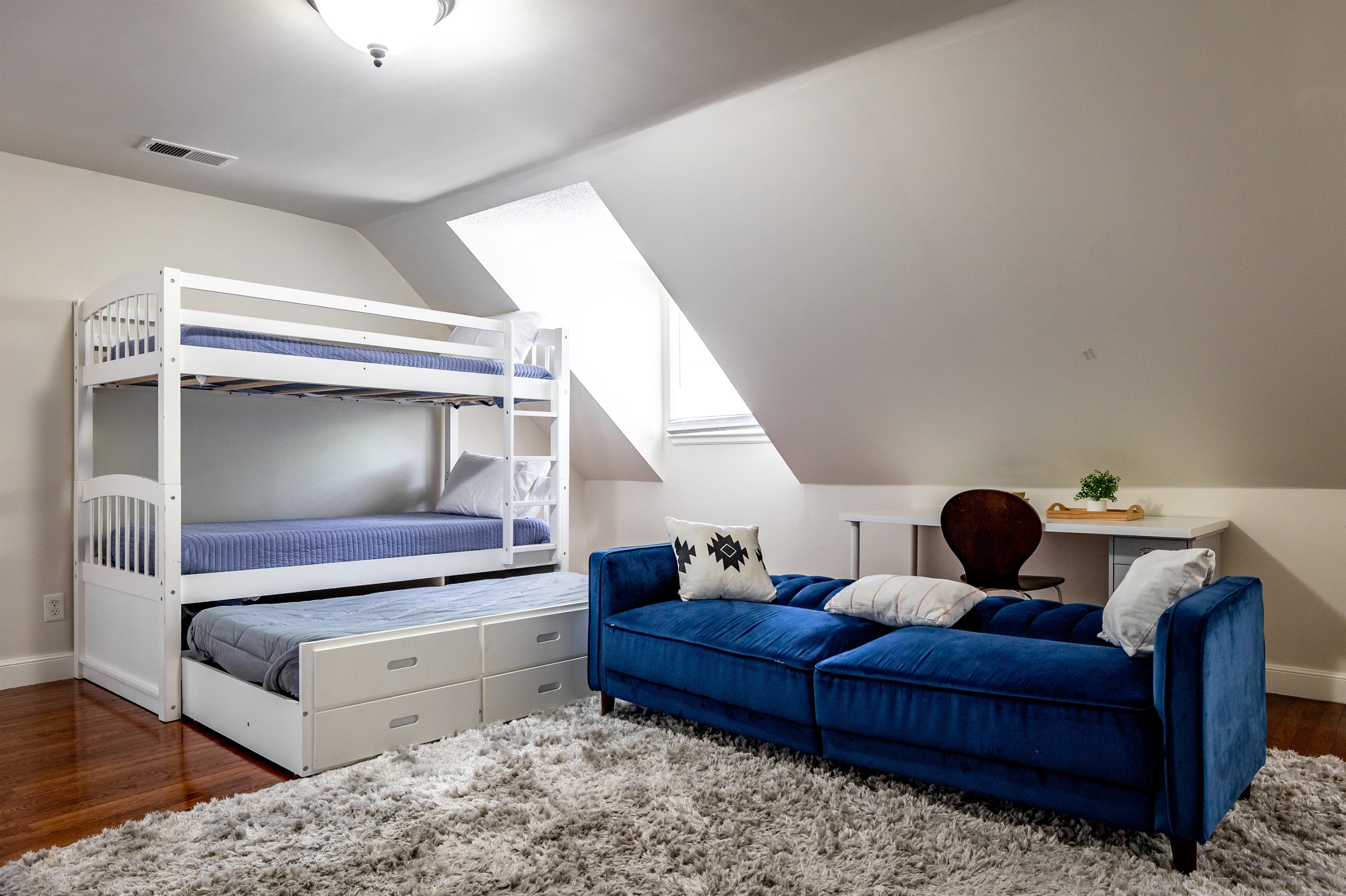 Upstairs bedroom: 3 twins, 1 queen, 1 sofa bed. Desk and TV
