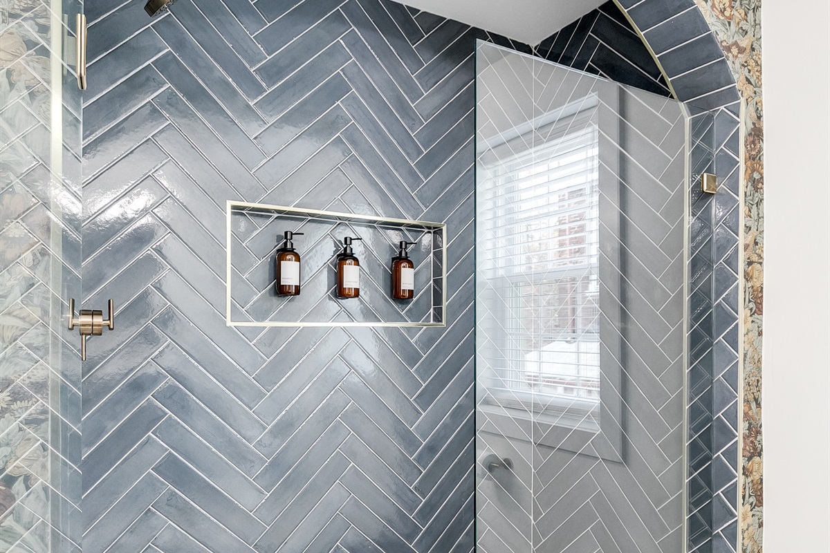 Spa-Like Retreat: Experience luxury with a stunning glass shower and elegant herringbone tiles!