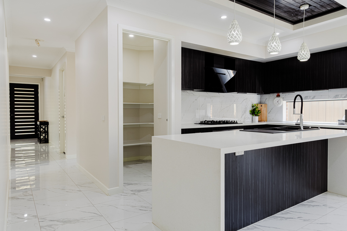 Cook, serve and gather around the kitchen island, with the pantry, appliances and open layout keeping the stay simple and comfortable.
