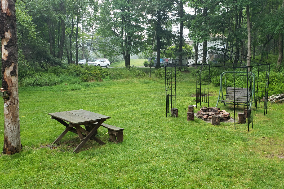 Large  backyard with cozy fire pit