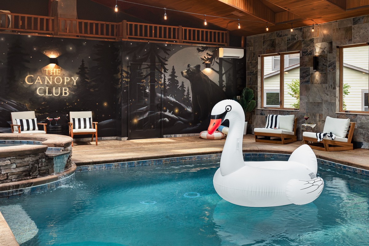 {Indoor Pool House} The signature Canopy Club mural, oversized swan float, and private heated pool make this one of the most memorable spaces in the house.