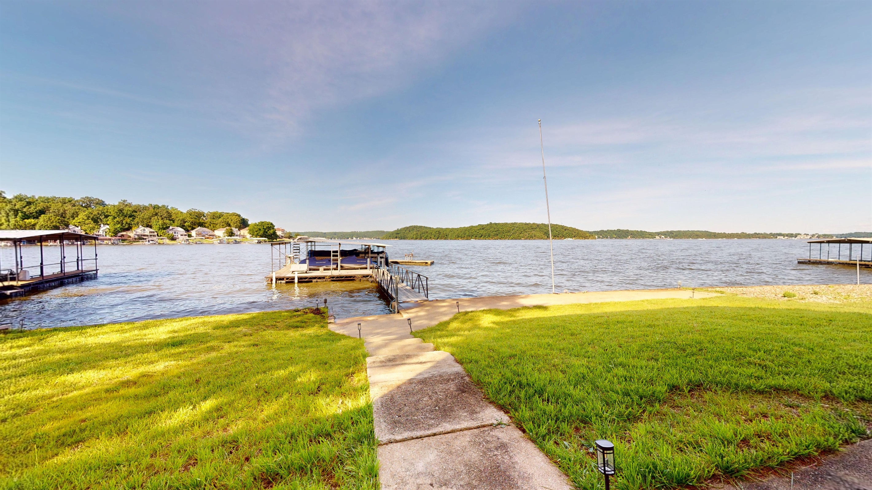 Level lawn between house and dock. Great area for watching boats and enjoying the sun from land.