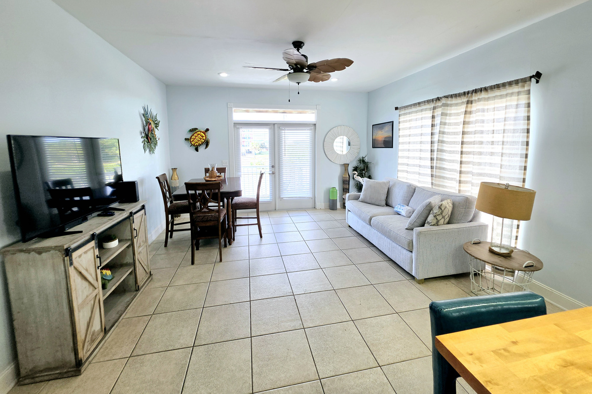 Living room flowing into the dining area, with French doors