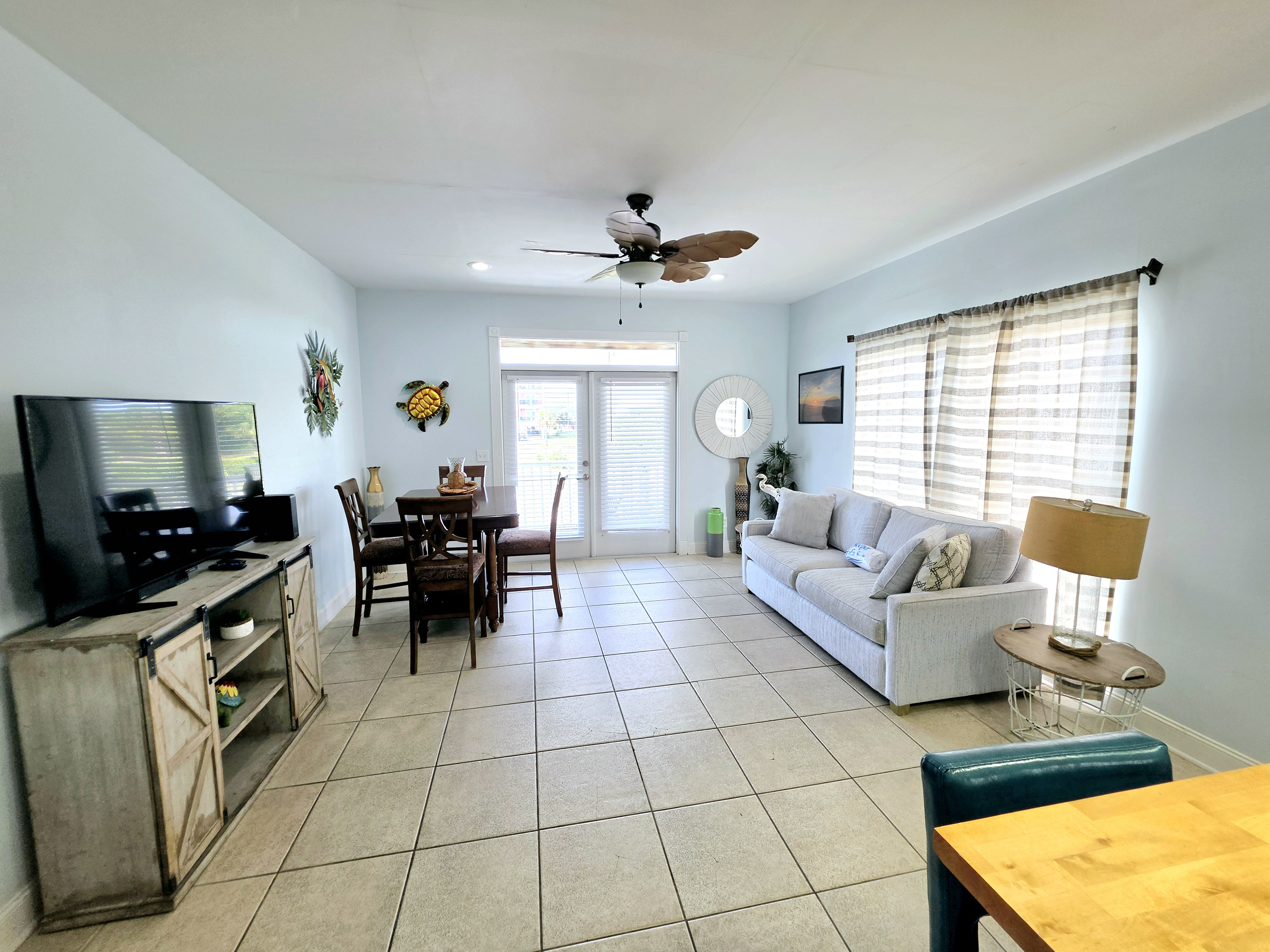 Living room flowing into the dining area, with French doors