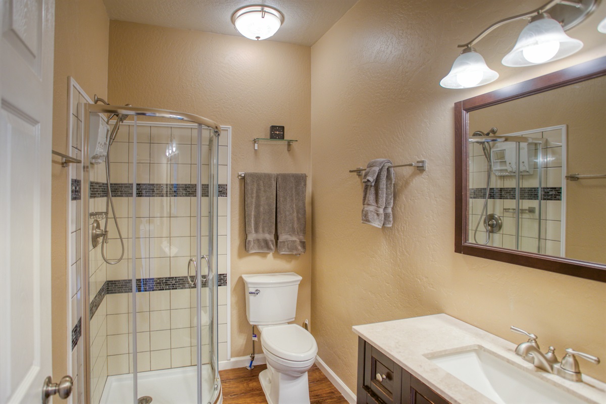Spacious walk-in shower in the primary bathroom offers pure relaxation.