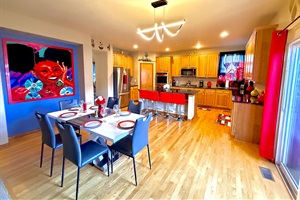Vast kitchen and dining space overlooking a charming patio, offering a delightful atmosphere for dining and unwinding